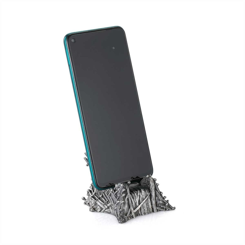 The Game of Thrones Iron Throne Phone Cradle 0160002 is sitting on top of a metal stand.