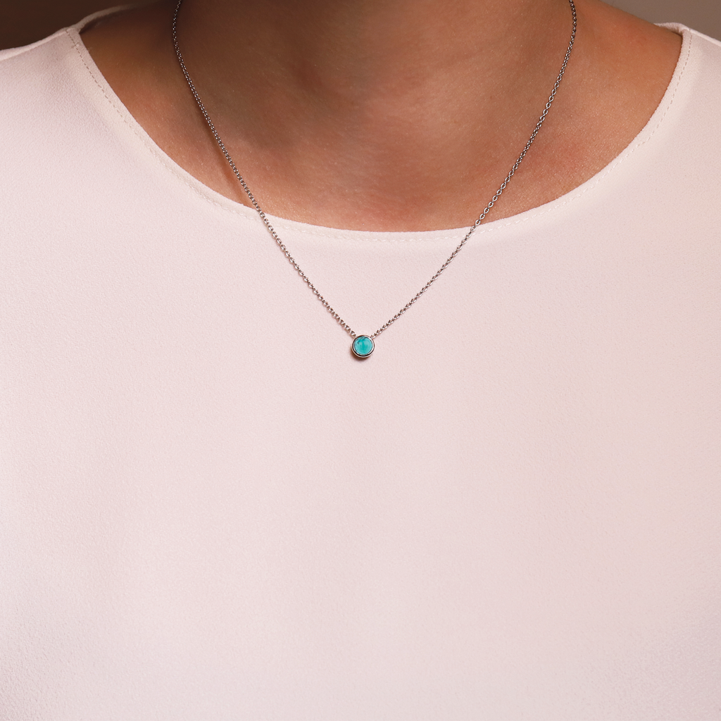 A woman wearing a TI SENTO Milano Necklace 3845TQ with a turquoise stone.