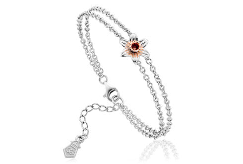 A Clogau Daffodil Bracelet 3SDMB with a flower and a red stone.