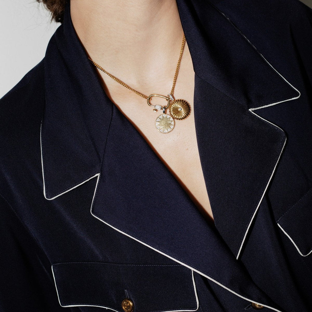A woman wearing a navy pajama shirt with a TI SENTO – Milano Locket Pendant 6797ZY necklace.
