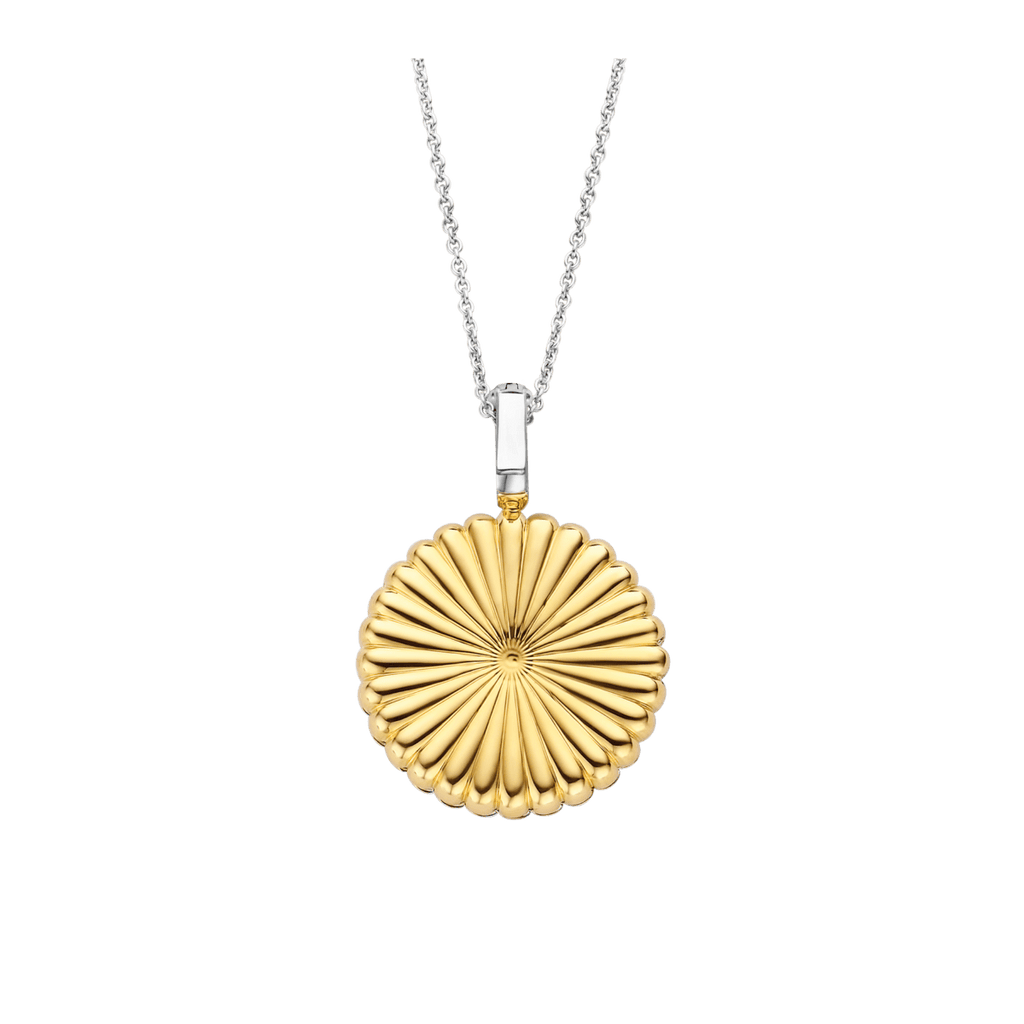 A gold TI SENTO – Milano Locket Pendant 6797ZY with a circular design on a black background.