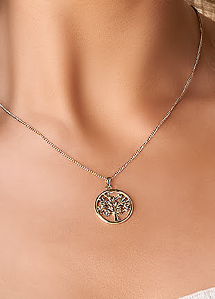 A woman wearing a necklace with the Tree of Life Pendant GTOL0015.