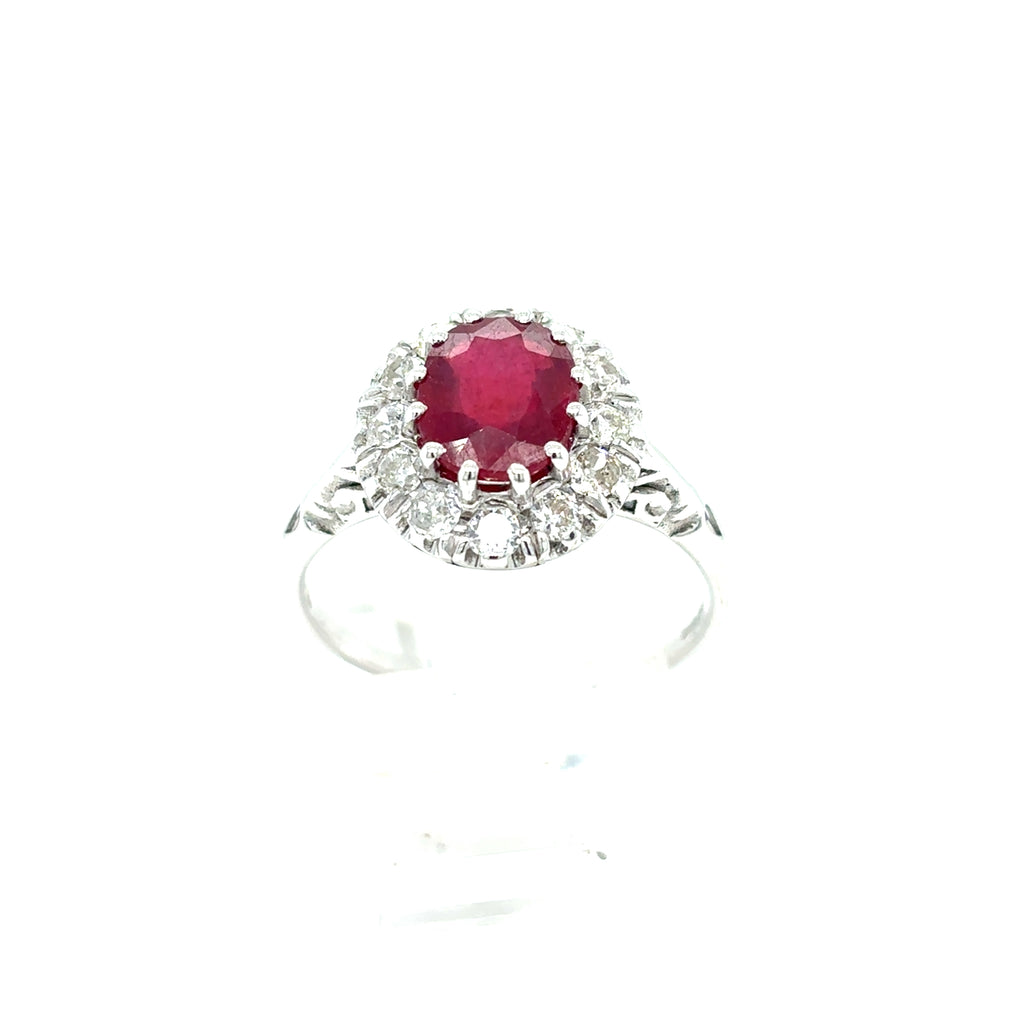 A dazzling 9ct white gold Ruby & Diamond Cluster Halo Set Dress Ring featuring a central oval ruby surrounded by a sparkling halo of diamonds.