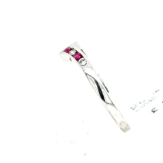 The Ruby & Diamond Wishbone Dress Ring in 9ct white gold features two small rubies and two small diamonds set diagonally, combining classic elegance with a modern, stylish design.