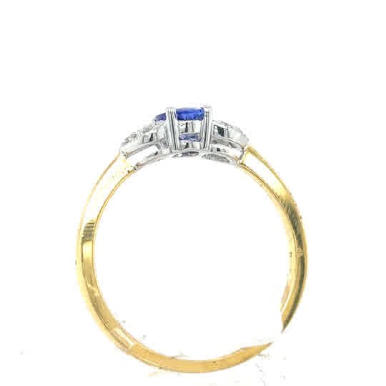 Tanzanite and Diamond Cluster Dress Ring in 18ct yellow gold, featuring a blue center gemstone with diamonds on each side, shown in a side view against a white background.
