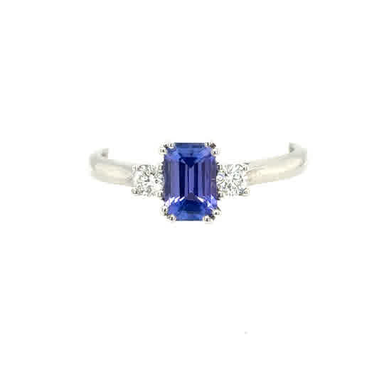 A stunning Tanzanite and Diamond Trilogy Dress Ring in 9ct white gold, featuring a central tanzanite flanked by sparkling diamonds on each side.