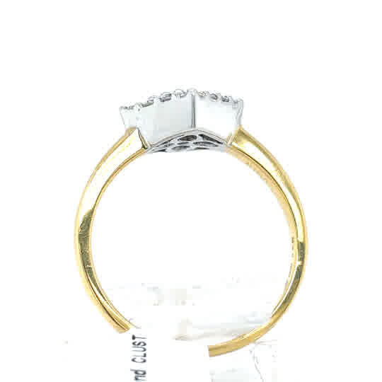 The Tanzanite and Diamond Cluster Dress Ring features multiple stones in an 18ct yellow gold setting, shown from the side against a plain white background.