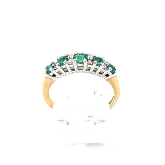 The Emerald and Diamond Half Eternity Ring in 9ct yellow gold showcases green emeralds and sparkling diamonds set in a white metal prong setting, visible from the side.