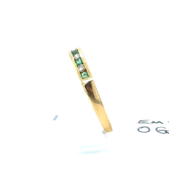 The Pre-Loved Emerald and Diamond Half Eternity Ring in 9ct yellow gold features three green emeralds and two diamonds set in a row, displayed on a plain white background.