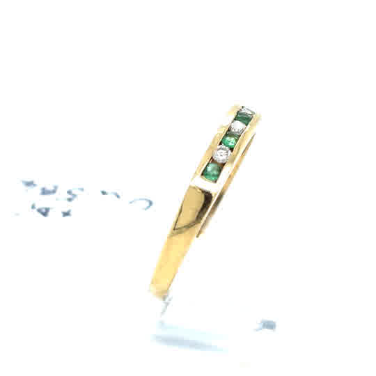 The Pre-Loved Emerald and Diamond Half Eternity Ring in 9ct yellow gold features alternating emerald and diamond stones set on the band, displayed against a white background.
