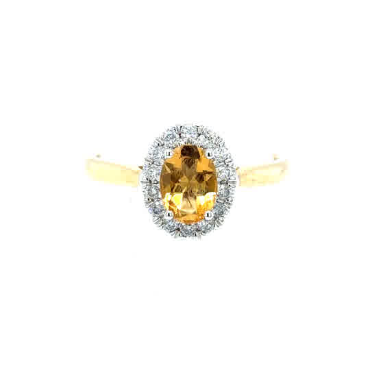 The Citrine & Diamond Halo Dress Ring features an oval citrine center with a diamond halo, set in 9ct yellow gold against a white background.