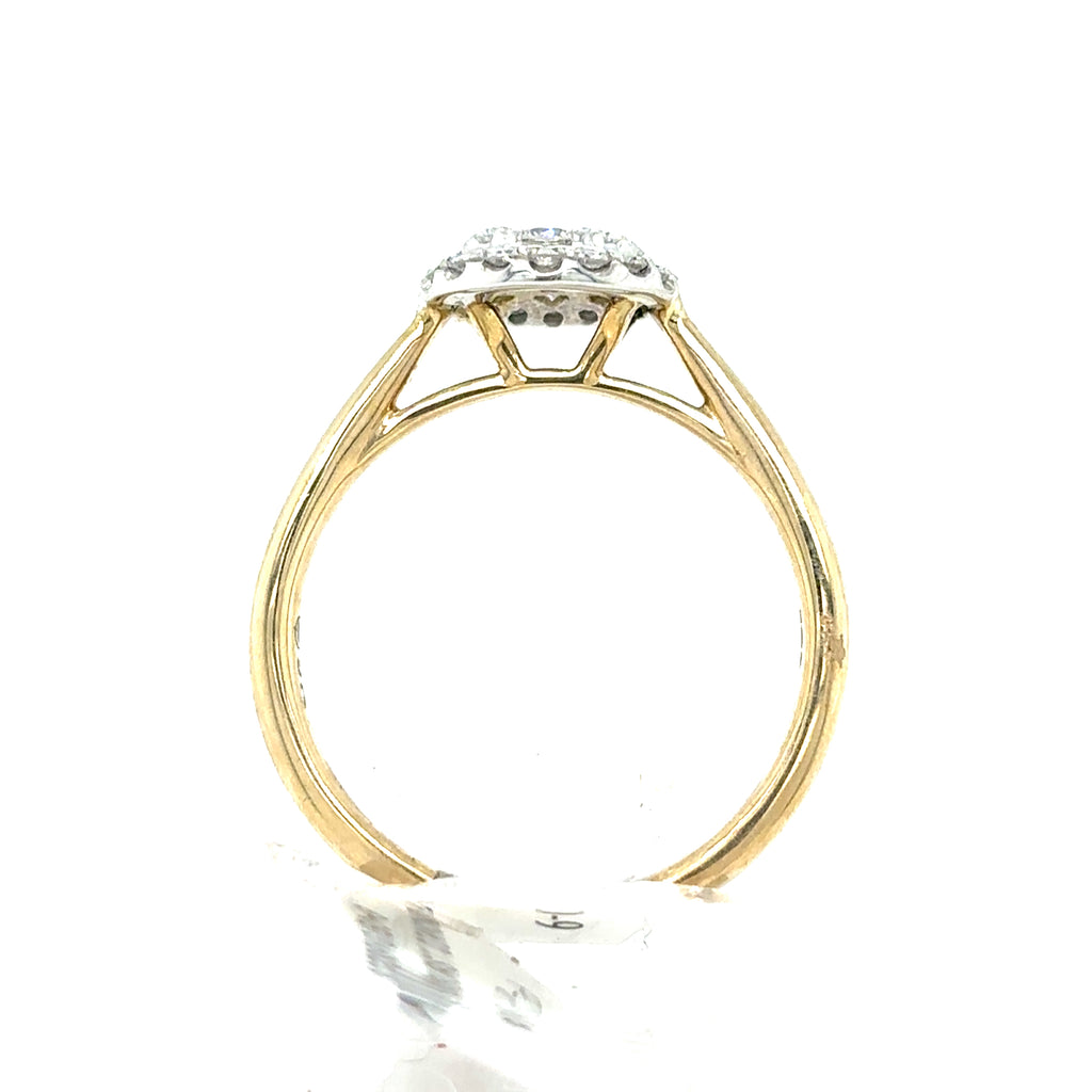 The Starburst Canadian Diamond Round Engagement Ring in 9ct Yellow Gold is shown from the side, highlighting its raised setting with a central gemstone. Ethically-sourced Canadian diamonds complete this elegant design against a white background.