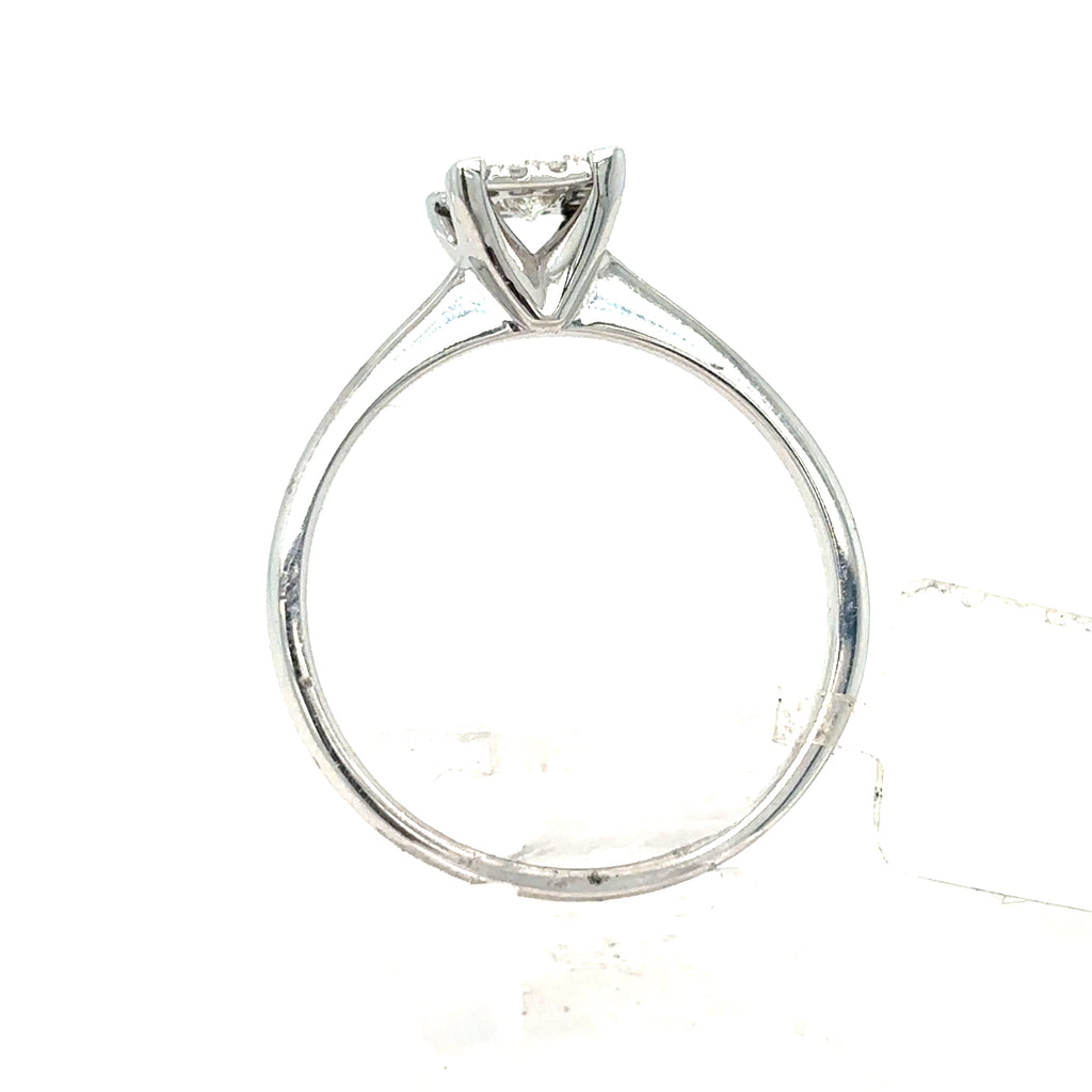 The Starburst Canadian Diamond Princess Cut Engagement Ring in 9ct white gold is shown with a single princess-cut diamond in a prong setting, displayed on a transparent stand against a white background.