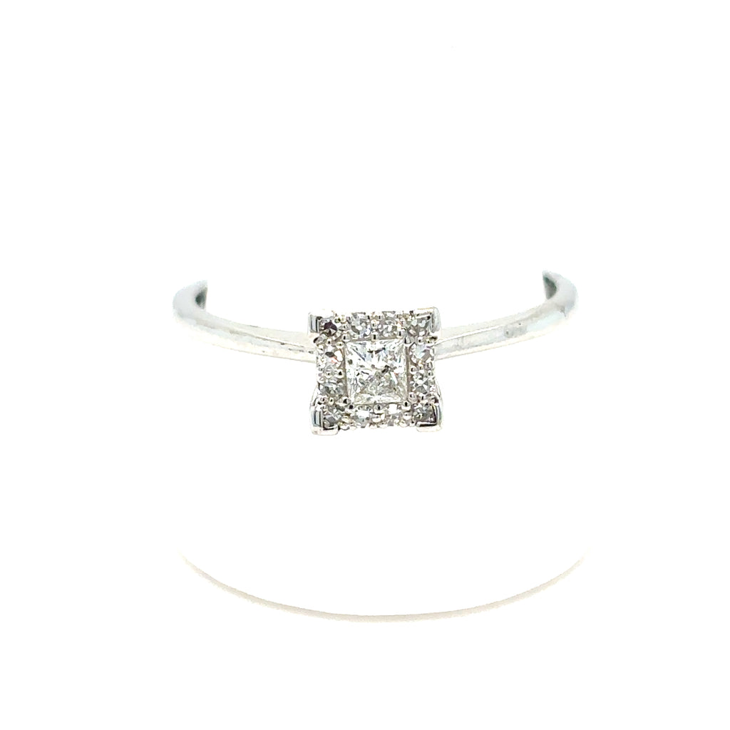 The Starburst Canadian Diamond Princess Cut Engagement Ring in 9ct white gold features a princess cut central diamond, surrounded by smaller diamonds on a thin band, shown against a white background.