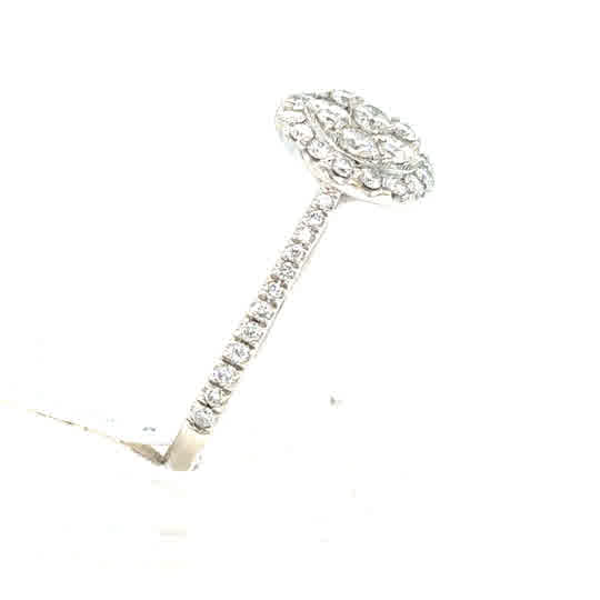 The Starburst Canadian Diamond Round Engagement Ring in 9ct white gold features a round diamond halo cluster with a band set with small diamonds, shown on a white background.