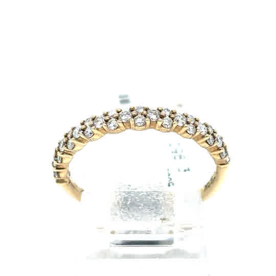The Starburst Canadian Diamond Half Eternity Ring in 9ct yellow gold showcases a row of round Canadian diamonds set along the top half of the band, elegantly displayed on a clear stand.