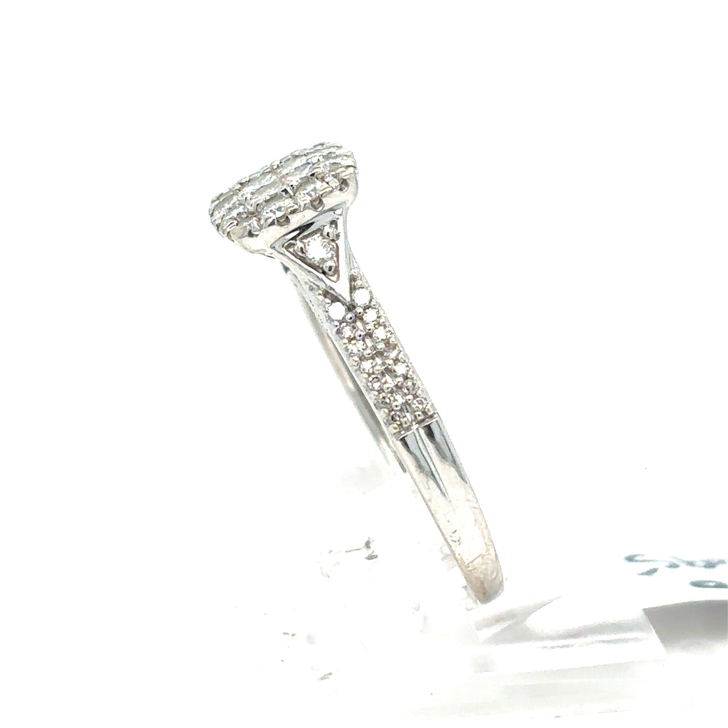 The Pre-loved Diamond Cluster Engagement Ring in 9ct white gold features a diamond cluster on a sleek, stone-adorned band, shown from the side.