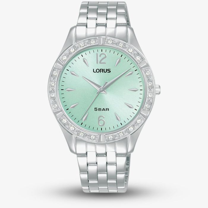 The Lorus Women’s Stainless Steel Quartz Watch RG263WX9 features a light blue sunray dial, silver hour markers, a metal link band, and a bezel adorned with small clear stones for added elegance.