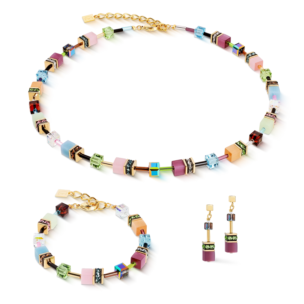 The Coeur de Lion GeoCUBE® Iconic necklace Art Nouveau gold is a colorful jewelry set with a handmade necklace, matching bracelet, and rectangular drop earrings showcasing geometric shapes in pastel and metallic hues.