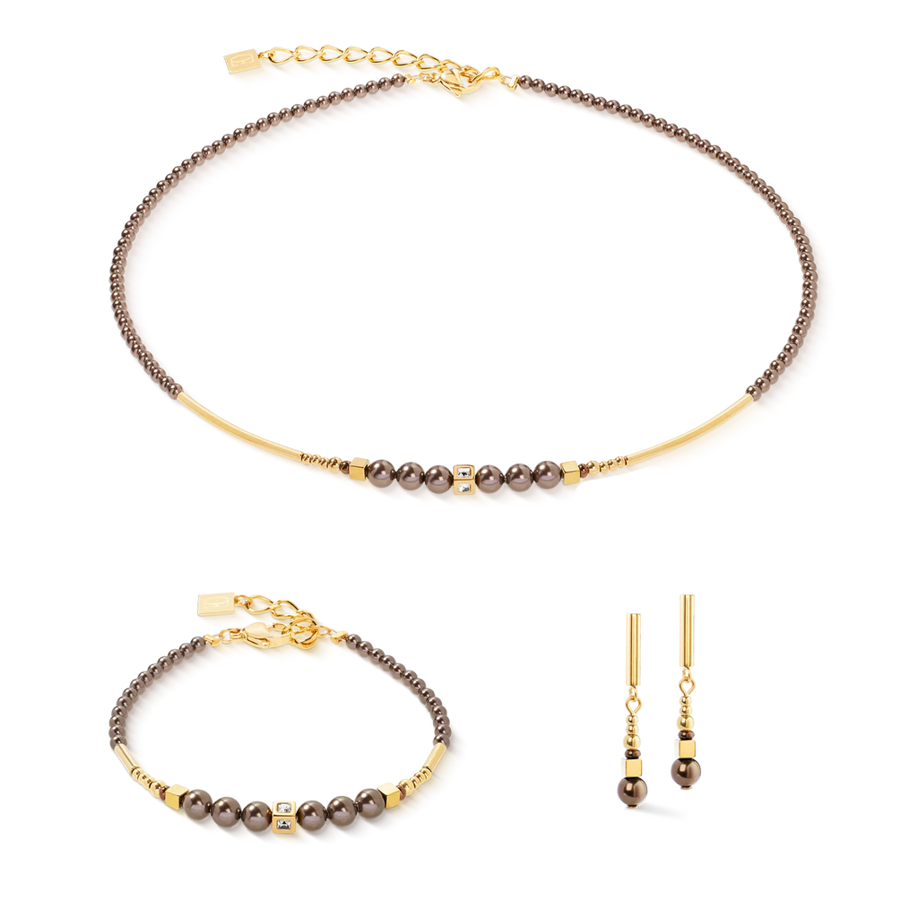 A coordinated jewelry set featuring the Coeur de Lion Necklace Shimmering Princess Pearls gold-brown, handmade in Germany with brown beads, gold accents, and matching gold drop earrings with Swarovski Crystal Pearls.