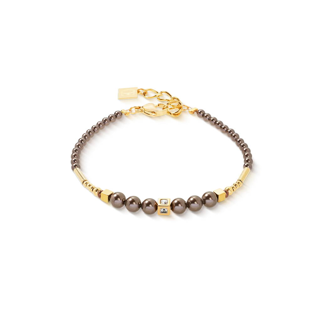 The Couer De Lion Bracelet Shimmering Princess Pearls gold-brown showcases dark Swarovski Crystal Pearls, gold accents, two stone-set square charms, and an adjustable gold clasp—handmade in Germany on a white background.