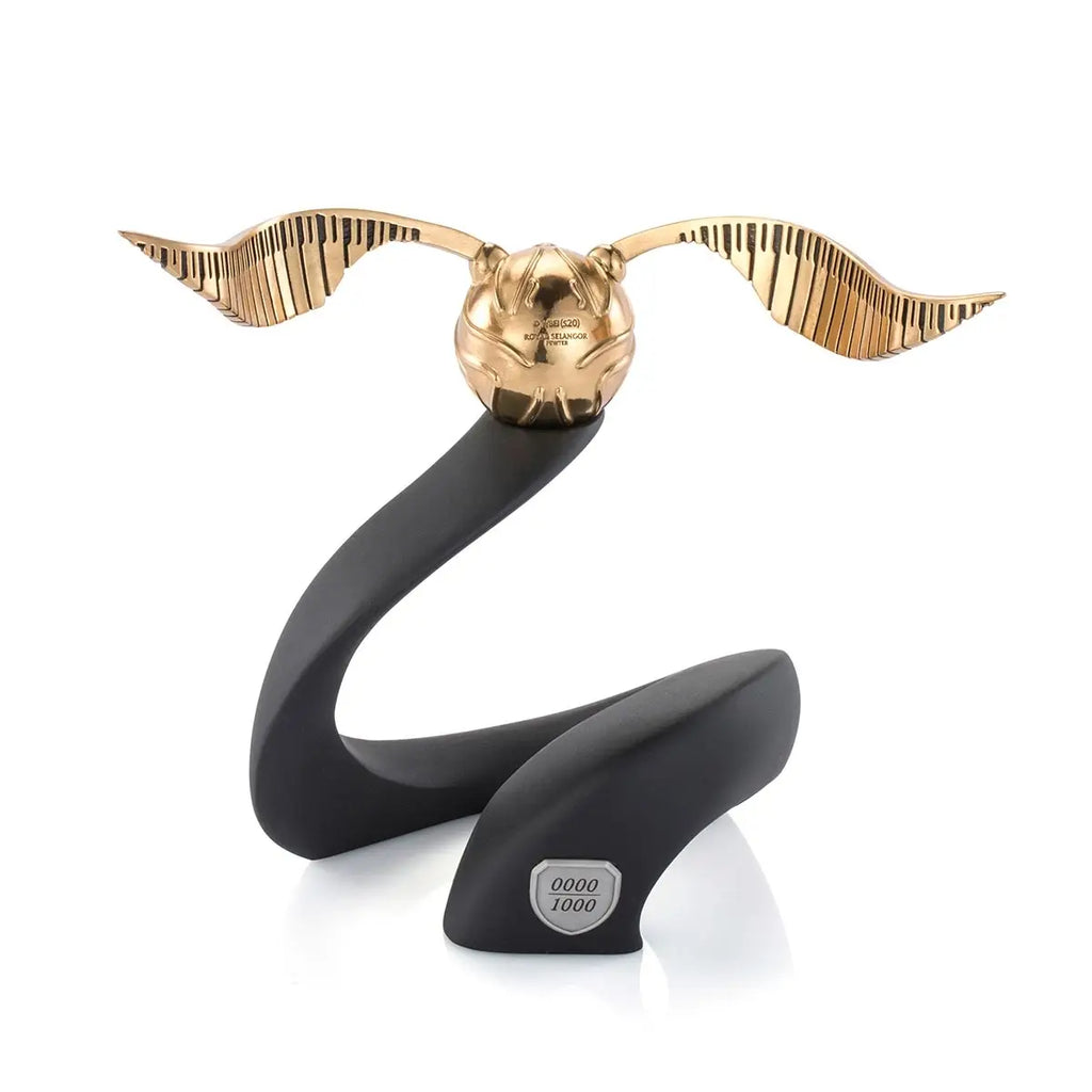 The Harry Potter Limited Edition Golden Snitch Replica features extended wings, a sleek black stand, and a numbered "0000/1000" plaque on the base, making it a must-have 24K gold collectible for fans and collectors.