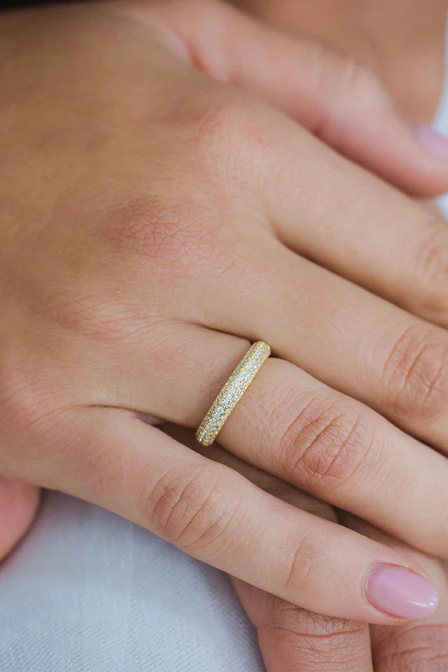 A close-up of a hand wearing the Georgini Goddess Pave Ring Gold, featuring a dazzling pavé effect with neatly manicured nails visible.