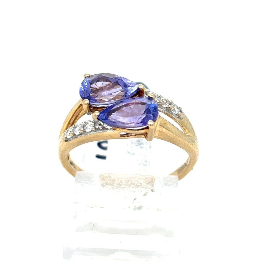 Gold ring with two purple gemstones on a white background