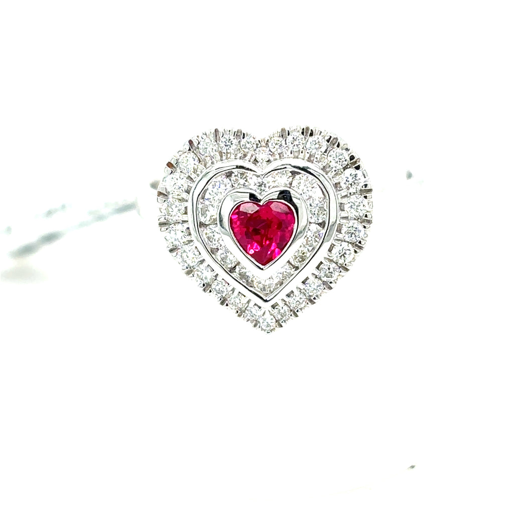 The Ruby & Diamond Heart Cluster Dress Ring features a central ruby in a heart-shaped design, set in 9ct white gold and surrounded by two dazzling diamond layers.
