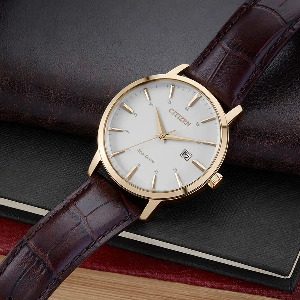 The Citizen Men's Eco-Drive Leather Strap Watch (BM7463-12A) is elegantly displayed atop a stack of leather-bound books.