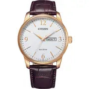 The Citizen Men's Eco-Drive Leather Strap Watch (BM8553-16A) features a white dial, gold-tone case, brown leather strap, and day-date display at 3 o’clock—powered by Eco-Drive technology for dependable timekeeping.