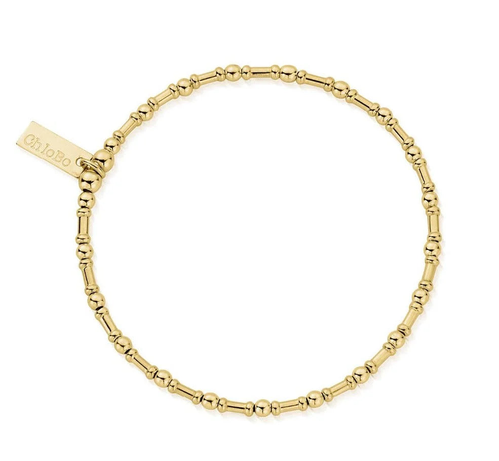 Inspired by fluid elegance, the ChloBo Rhythm Of Water Bracelet features gold beaded, stackable design with small and medium round beads and a rectangular "ChloBo" engraved tag.