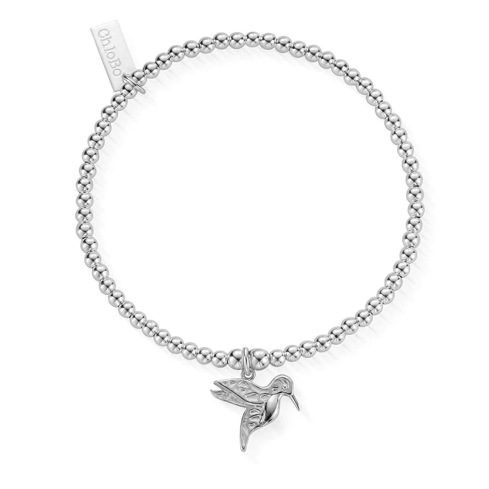 The ChloBo Cute Charm Hummingbird Bracelet is a silver beaded charm bracelet featuring a delicate hummingbird and a "chloBo" engraved tag—positive jewelry designed to inspire and uplift.