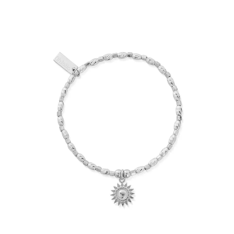 The ChloBo Soul Glow Sunshine Bracelet is a silver beaded bracelet with a sun-shaped charm and a rectangular tag, designed to inspire serenity and spiritual growth.