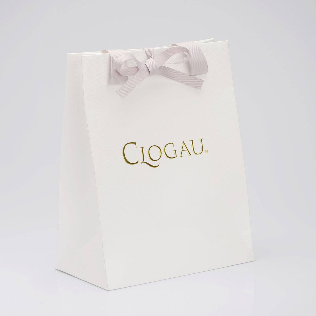 a white paper bag with a bow on it