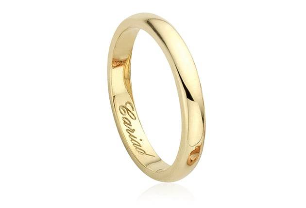 A Clogau 18ct Gold Welsh Wedding Ring – 3mm with the word 'love' engraved on it.