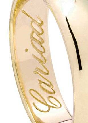 A Clogau 18ct Gold Welsh Wedding Ring – 5mm with the word 'carried' engraved on it.