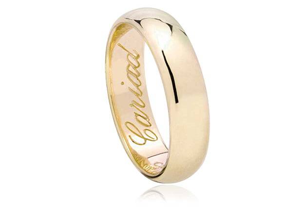 A Clogau 18ct Gold Welsh Wedding Ring - 5mm with the words 'loved' engraved on it.