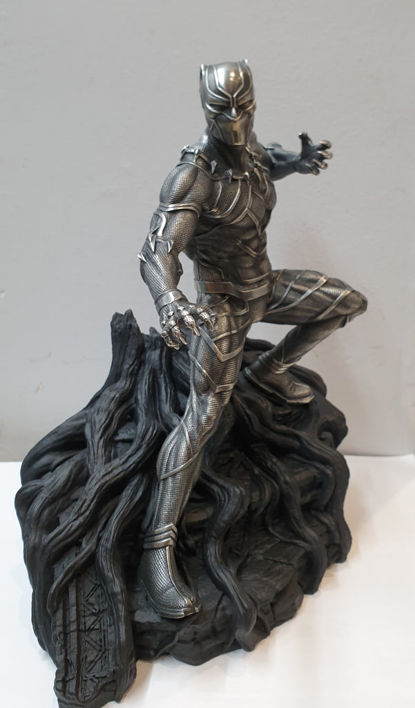 A Black Panther Figurine Limited Edition on top of a tree.