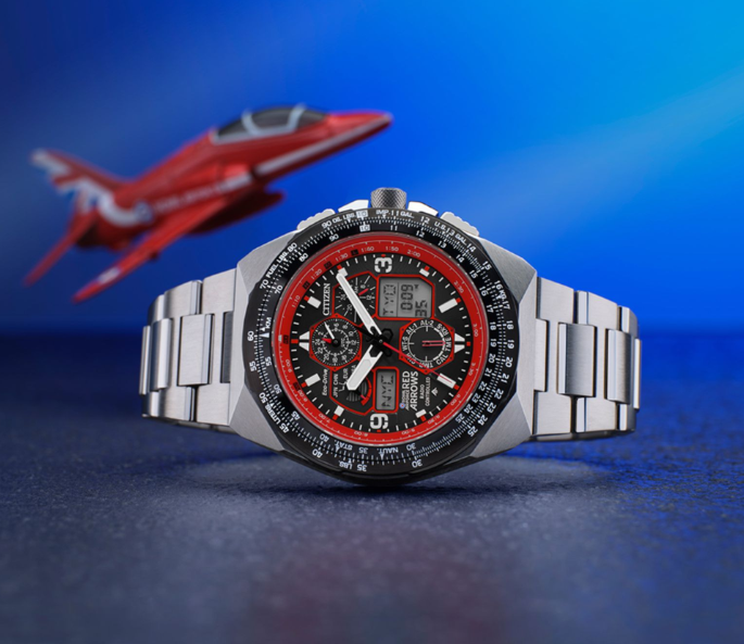 A Red Arrows Limited Edition Skyhawk A.T watch with a plane in the background.