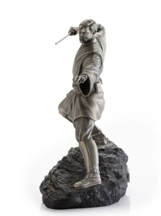 A Star Wars Obi-Wan Figurine – 0179035 holding a sword on a rock.