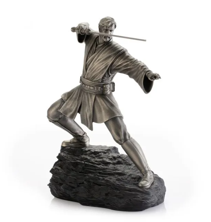 A Star Wars Obi-Wan Figurine - 0179035 with a sword on top of a rock.