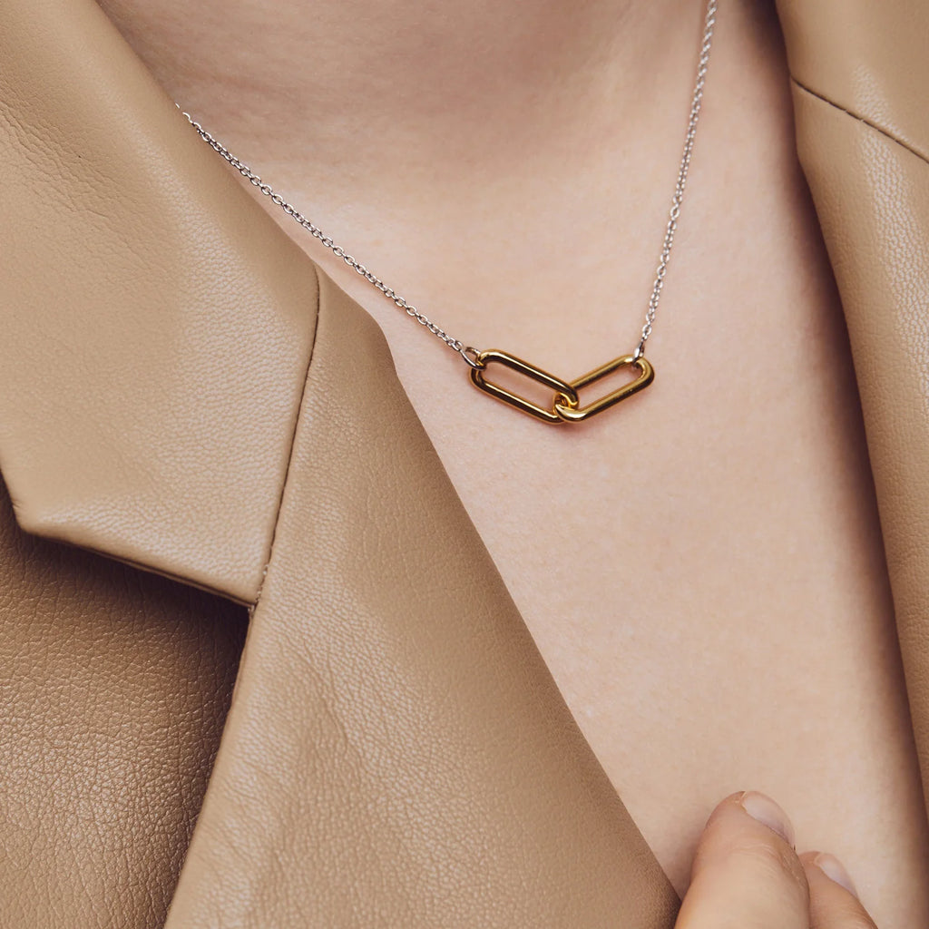 A woman wearing a tan jacket with a TI SENTO – Milano Paper Link Necklace 3966SY.