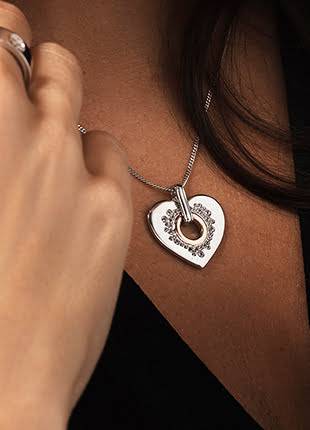 A woman wearing a Clogau Cariad Sparkle Heart Pendant. 3SCCP01.