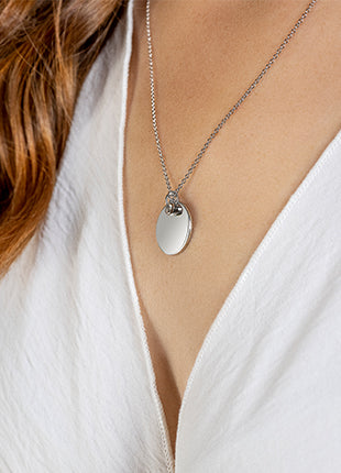 A woman wearing a Clogau Celebration June Birthstone Pendant 3SCLC0120 necklace.