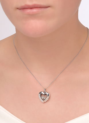 A woman wearing a Clogau Past Present Future® Inner Charm® Heart Pendant necklace.