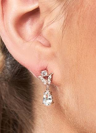 A close up of a woman's ear with a Clogau Kensington Fife Tiara Drop Earrings 3SKFDE.