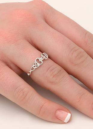 A woman's hand with a Clogau Lovespoon Ring 3SLSR3 on it.