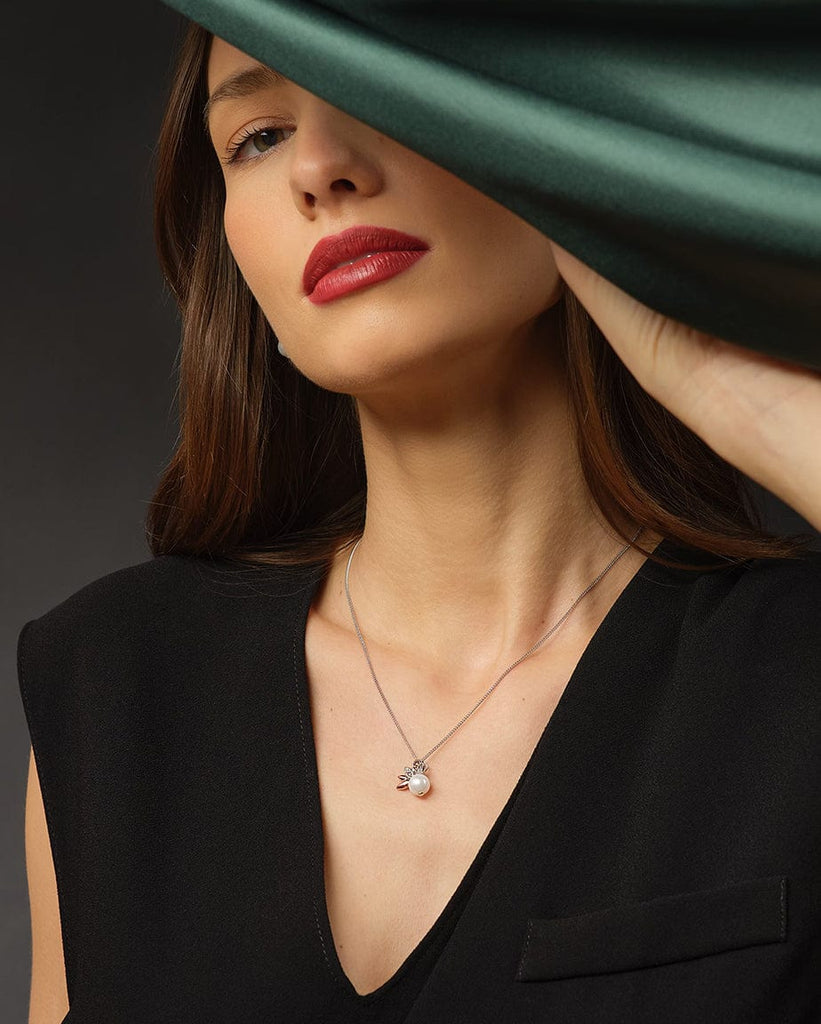 A woman wearing a black dress and a Clogau Lily of the Valley Pendant 3SLYV0600 necklace.