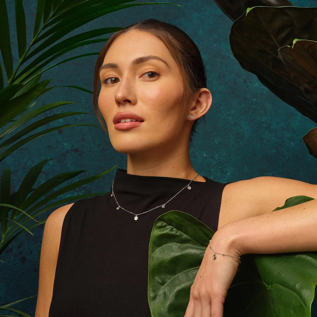 A woman is posing in front of a Clogau Tree of Life Insignia Bracelet 3STOL0602.